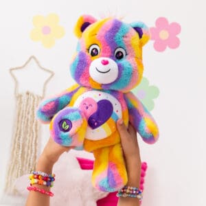 Care Bear Forever Bear being held by young girl.