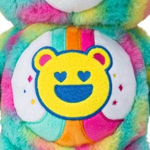 Close up of A colorful Good Vibes Bear plush toy from the Care Bears collection's belly, highlighting the emblem on its stomach.