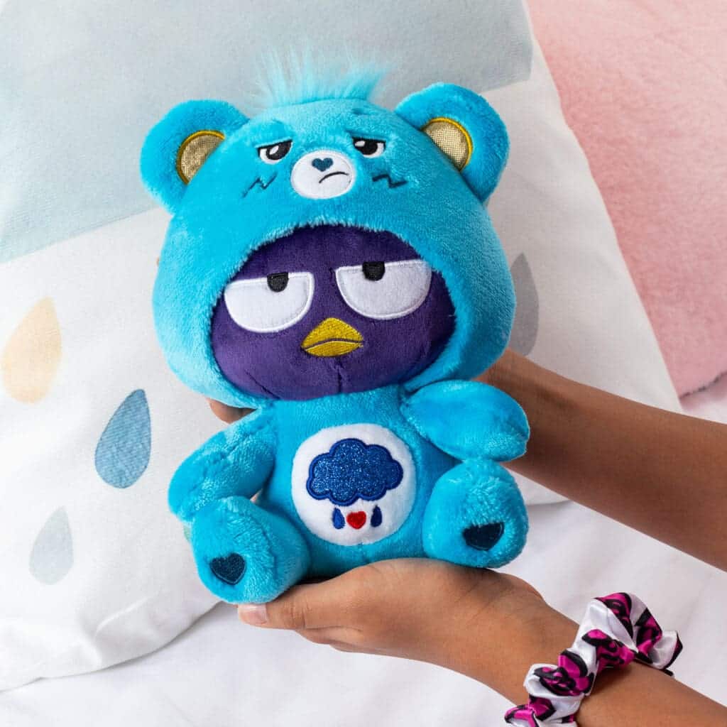 Grumpy Bear costume on bear in young girl's hands.