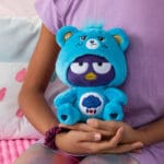 Grumpy Bear costume on bear in young girl's hands.