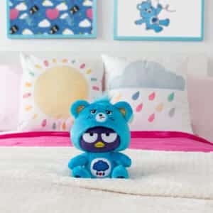 Grumpy Bear costume on bear sitting on bed.
