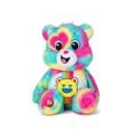 Care Bears Good Vibes Bear plush displayed on a white background, featuring bright colors and a cheerful expression, spreading positivity and good vibes.