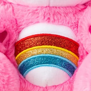 Care Bears Hello Kitty 2 Pack's pink bear's belly is close up, with a pretty glittery rainbow on it.
