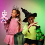Two little girls playing with the Glinda and Elphaba bears