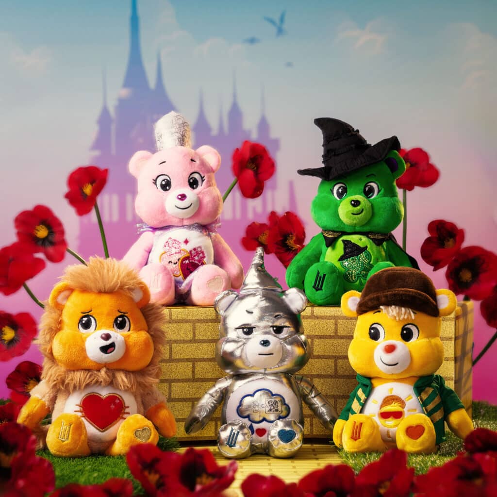 Photo of all five bears: Love-a-Lot Bear as Glinda, Good Luck Bear as Elphaba, Grumpy Bear as the Wicked Tin Man, Funshine Bear as the Scarecrow, Tenderheart Bear as the Lion