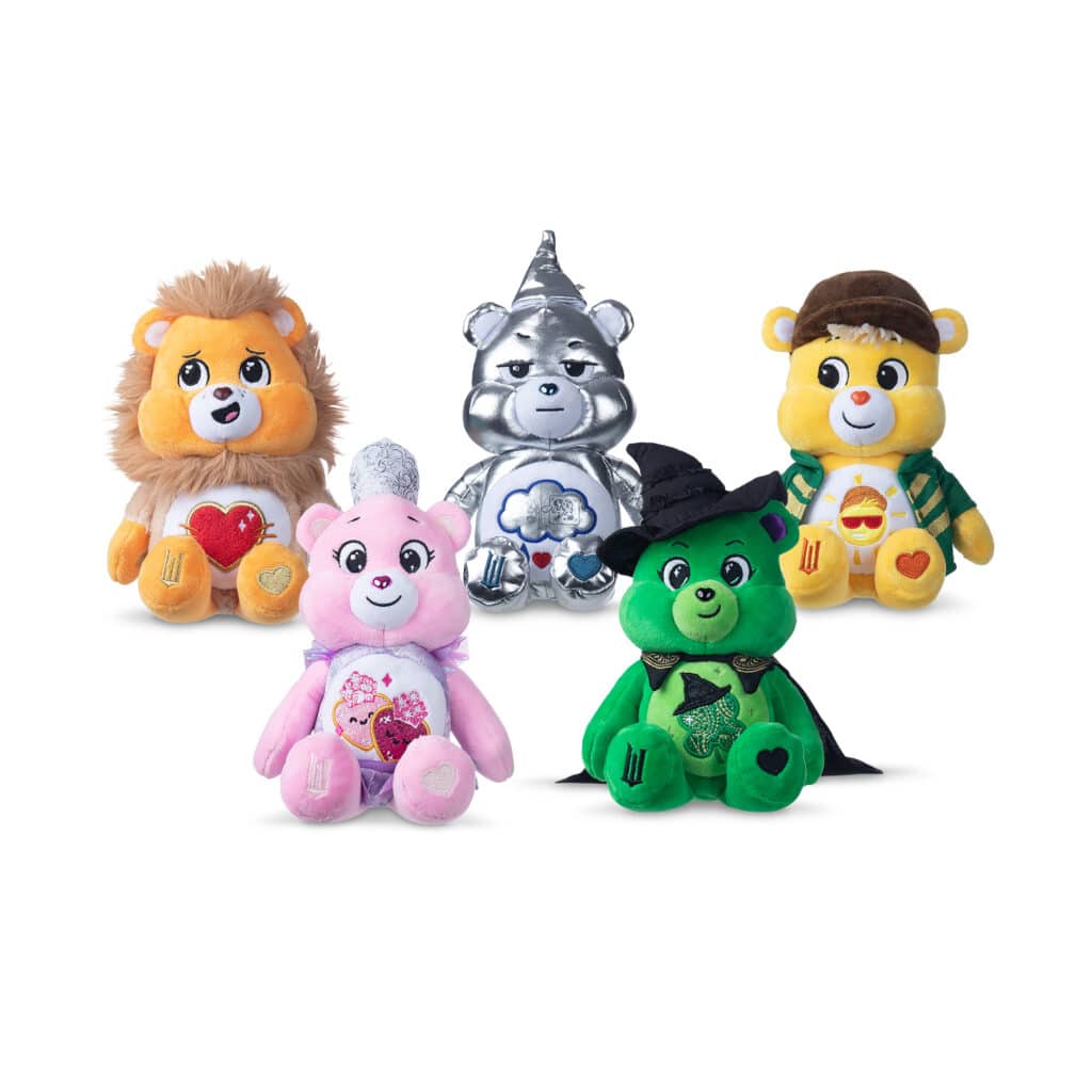 Photo of all five bears: Love-a-Lot Bear as Glinda, Good Luck Bear as Elphaba, Grumpy Bear as the Wicked Tin Man, Funshine Bear as the Scarecrow, Tenderheart Bear as the Lion
