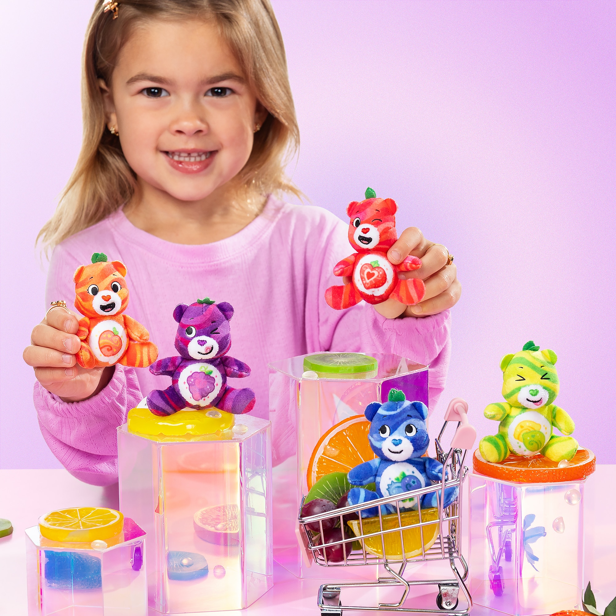 Little girl playing with the bears from the Micro Teenies Care Bears Fruity Bears 5-Pack