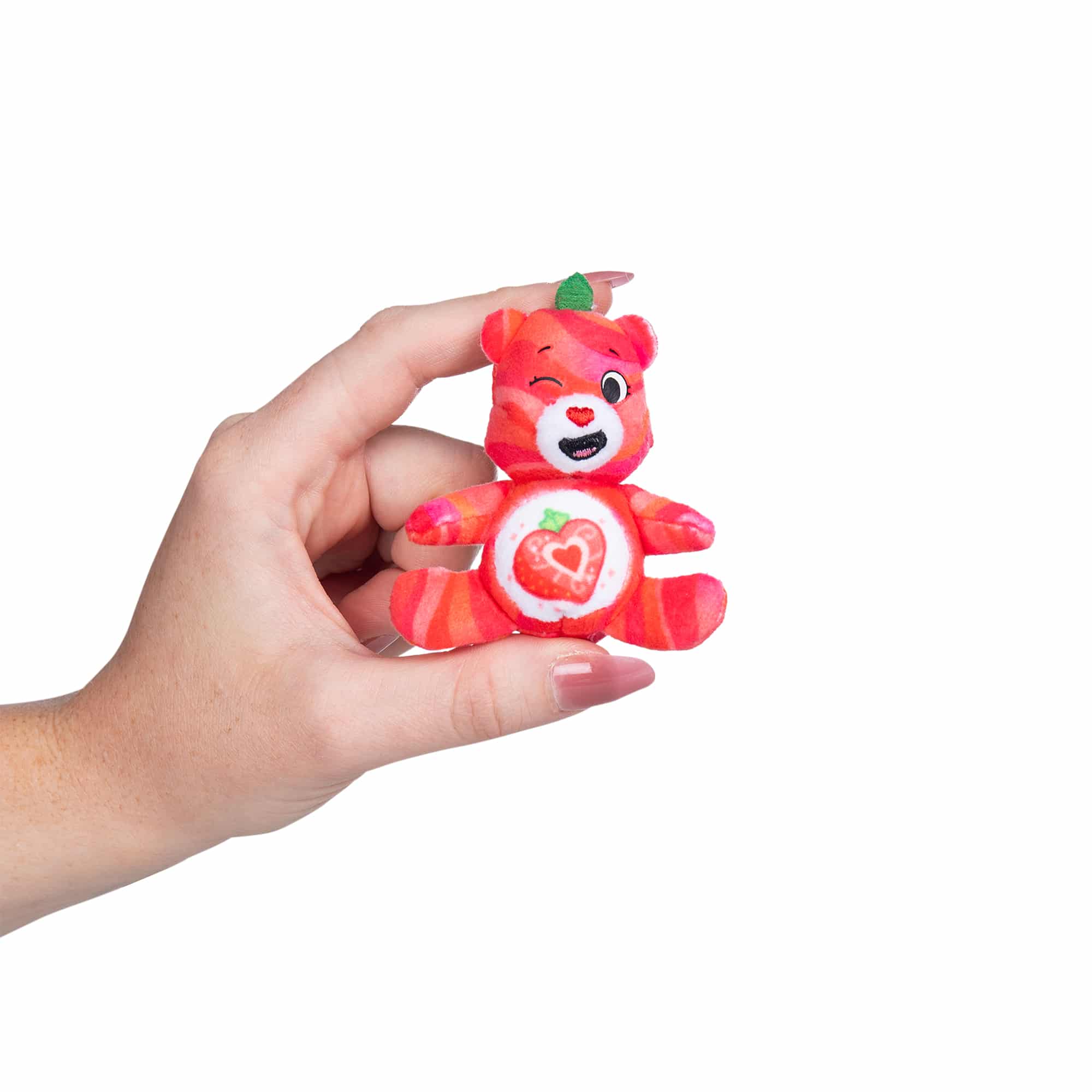 Micro Teenies Care Bears Fruity Bear compared to hand for size reference