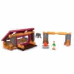 Display photo of the cabin from the front displaying the person, bear and firepit. All included in the Lincoln Logs Adventure Pod Cabin set