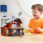 Child admiring the fully built Lincoln Logs Beechwood Retreat