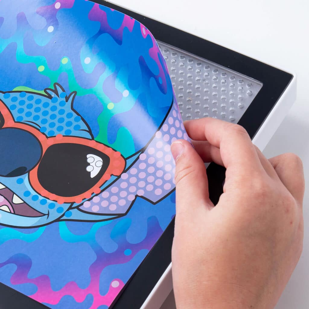 Photo shows how you can change the back drop of the Lite-Brite ColorPOP! Stitch