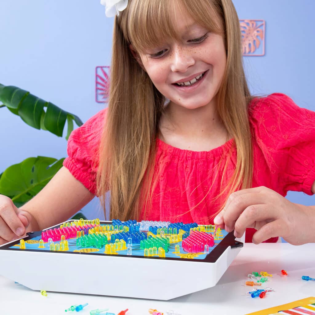 Little girl playing with the Lite-Brite ColorPOP! Stitch