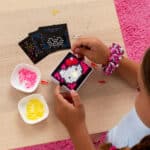 Little girl playing with the Lite-Brite, Hello Kitty Mini