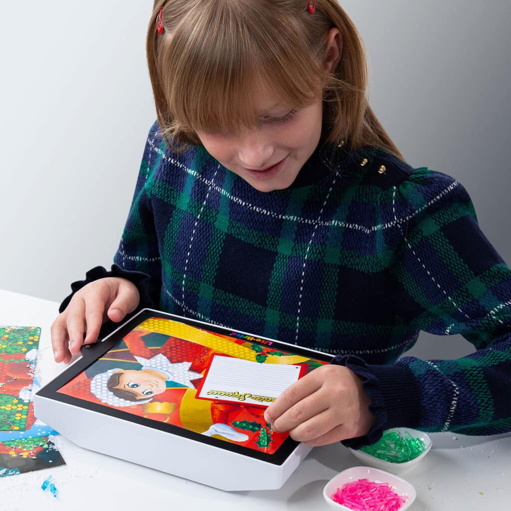 Little girl playing with the Lite-Brite ColorPOP! Elf on the Shelf