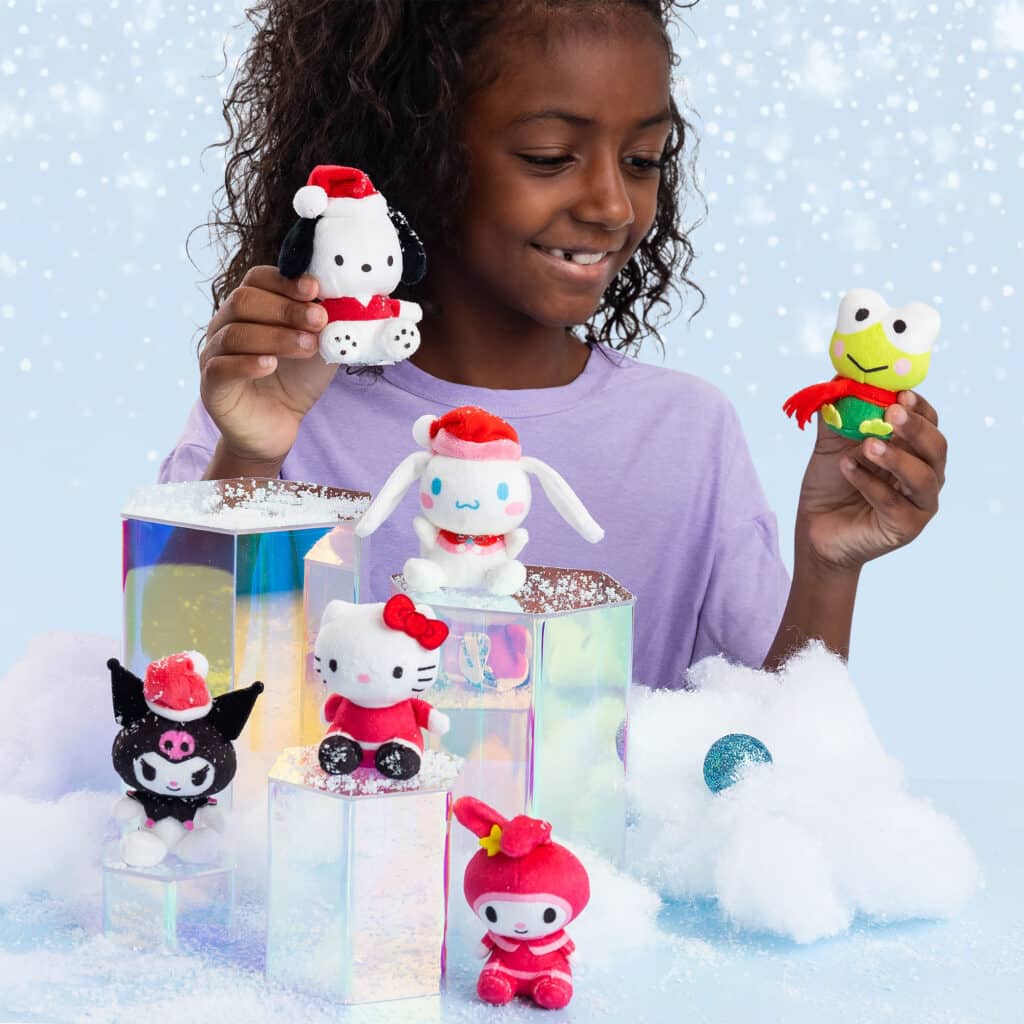 Little girl playing with the Characters from the Micro Teenies Hello Kitty & Friends Holiday Stocking Stuffer Assortment