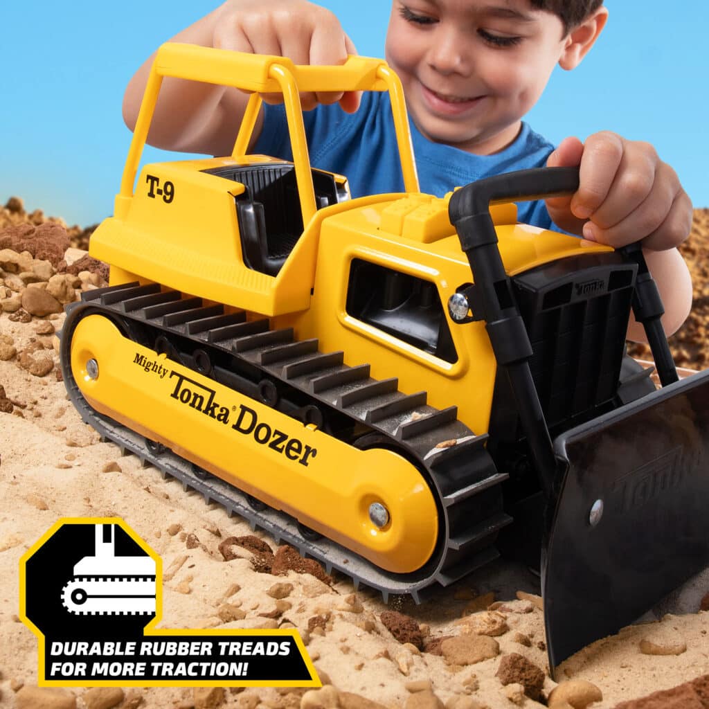 Kid playing with the Tonka Retro Bull Dozer in the rock