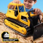 Kid playing with the Tonka Retro Bull Dozer in the rock