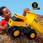 Little boy playing with the Tonka - Next Gen Mighty Dump Truck in the rock