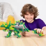 Little boy building a dino from the K'NEX Dynamic Dinos 6-in-1 Building Set