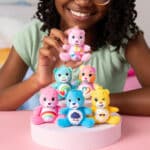 Little Girl playing with all the bears from the Micro Teenies Care Bears Assortment - Tiny Collectible Plush!