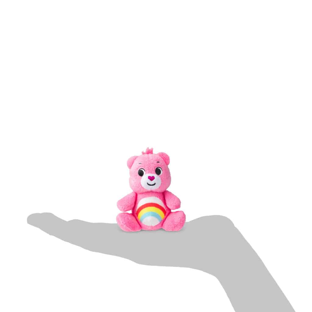Size scale of how big the bears are in comparison to a hand from the Micro Teenies Care Bears Assortment - Tiny Collectible Plush!