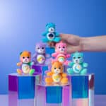 Someone playing with all the bears from the Micro Teenies Care Bears Assortment - Tiny Collectible Plush!