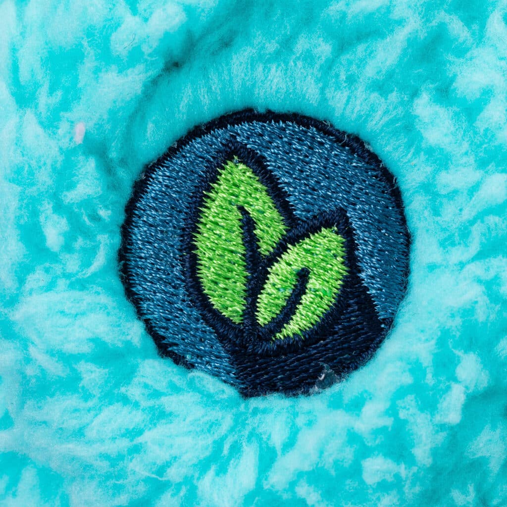 Eco Friendly foot badge on the Care Bears Medium Cozy Bedtime Bear Plush