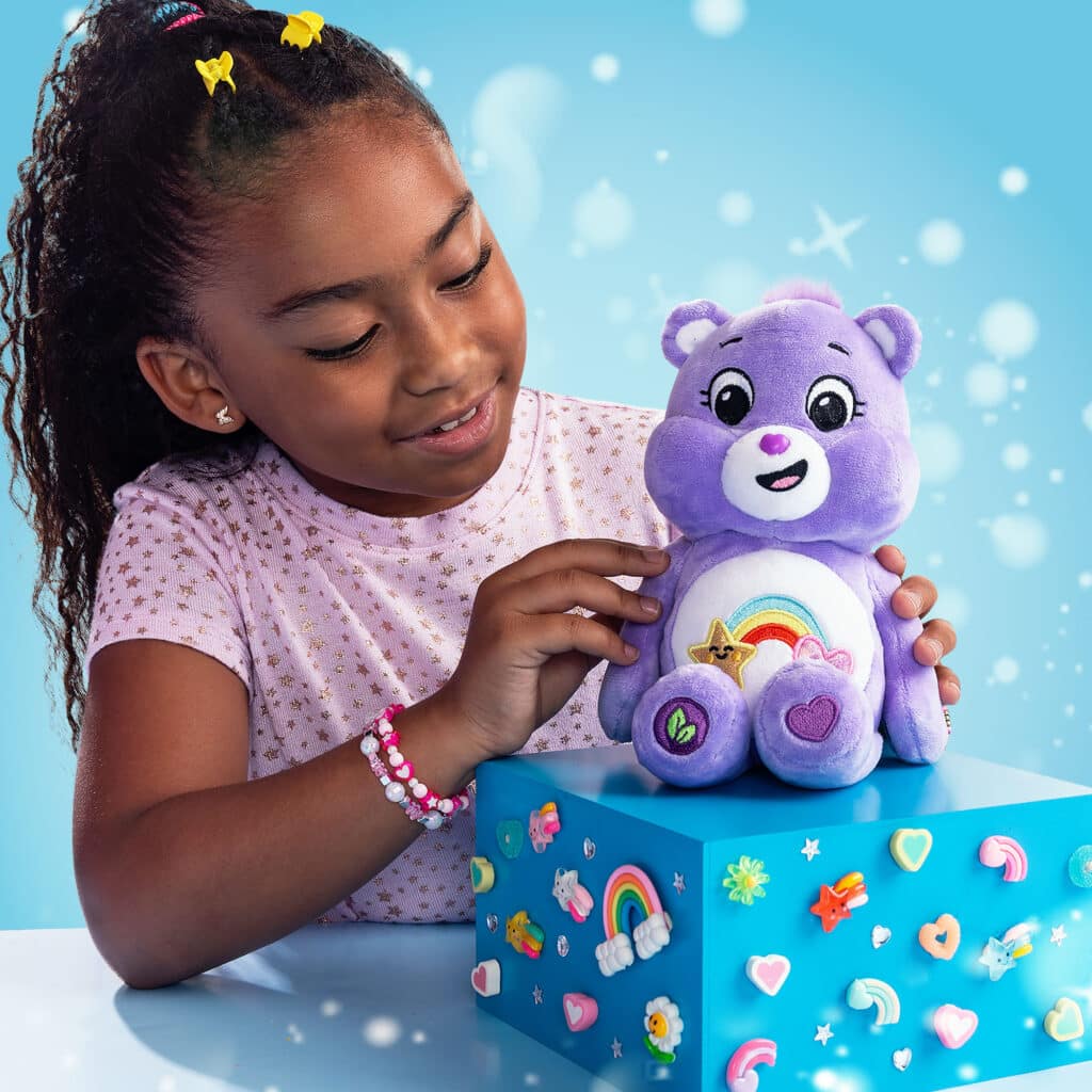 Little girl playing with the Care Bears - 9" Fun Size Sparkle Plush - Best Friend Bear
