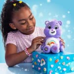Little girl playing with the Care Bears - 9" Fun Size Sparkle Plush - Best Friend Bear