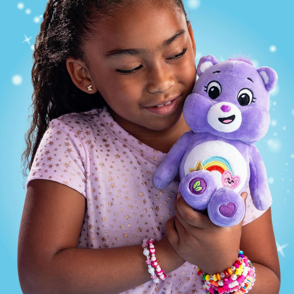 Little girl hugging the Care Bears - 9" Fun Size Sparkle Plush - Best Friend Bear