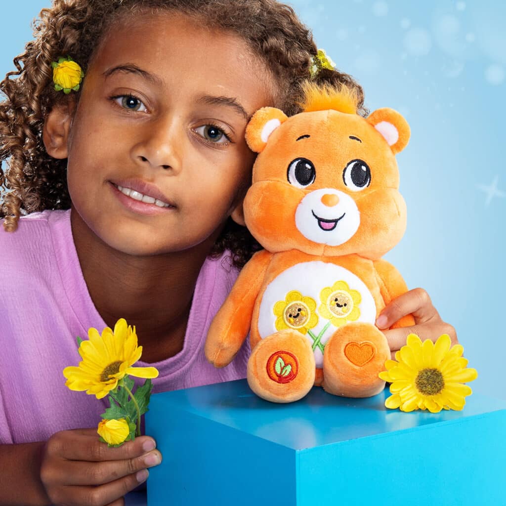 Child playing with the Friend Bear from the Fun Size Sparkle Collection