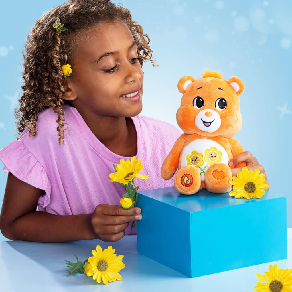 Child playing with the Friend Bear from the Fun Size Sparkle Collection