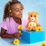 Child playing with the Friend Bear from the Fun Size Sparkle Collection