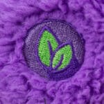 Close up of Cozy Share Bear eco friendly foot badge