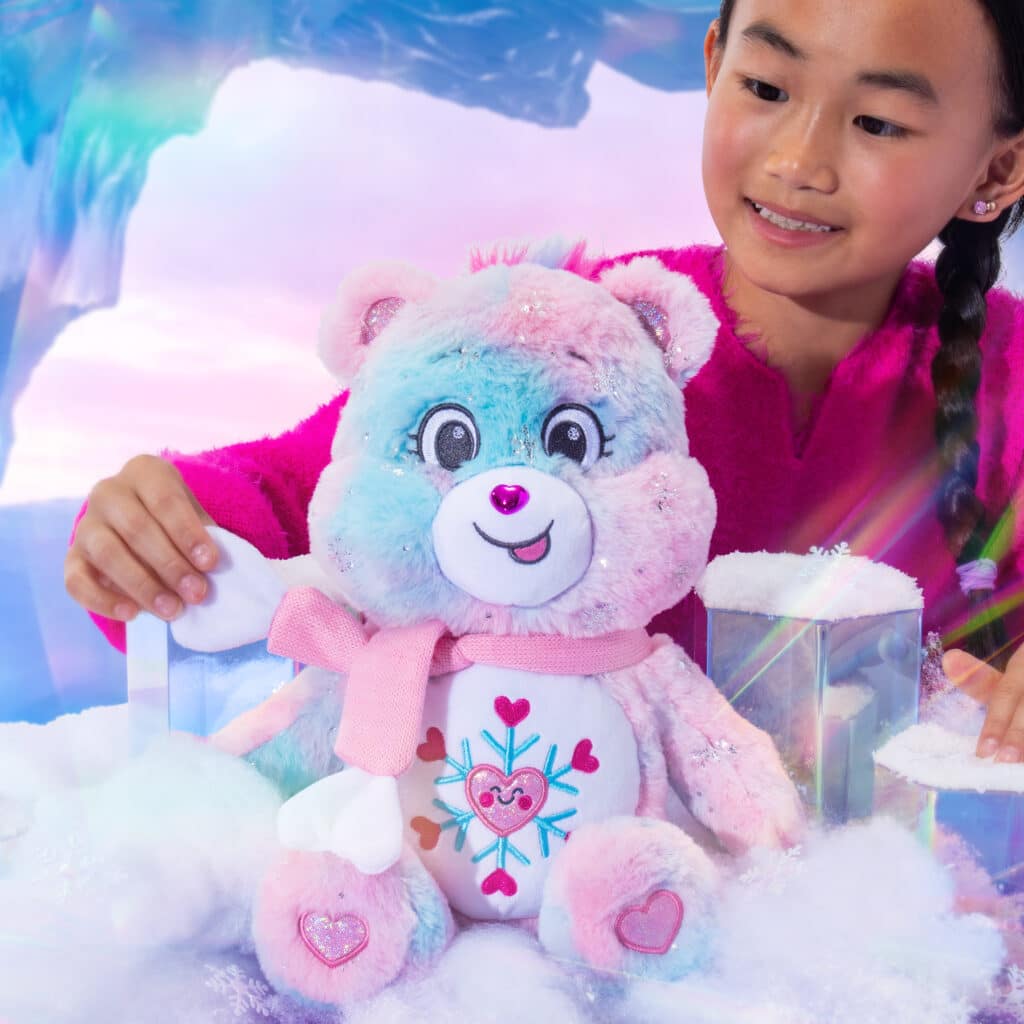 Little girl playing with the Care Bears Collector's Edition Snowflake Sparkle Bear