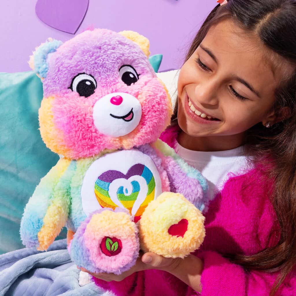 Child playing with Care Bears Medium Cozy Togetherness Bear Plush