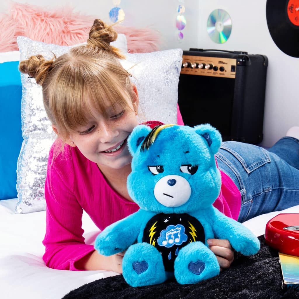 Child playing with Care Bears - 14" Medium Plush - Rock-a-Lot Grumpy Bear