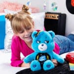 Child playing with Care Bears - 14" Medium Plush - Rock-a-Lot Grumpy Bear