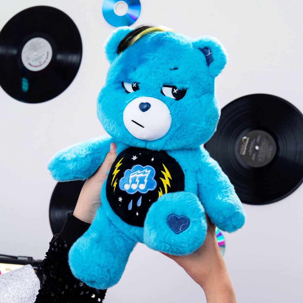 Someone holding up the Care Bears - 14" Medium Plush - Rock-a-Lot Grumpy Bear
