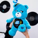 Someone holding up the Care Bears - 14" Medium Plush - Rock-a-Lot Grumpy Bear