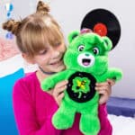 Little girl holding Care Bears - 14" Medium Plush - Rock-a-Lot Good Luck Bear