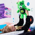 Child playing with Care Bears - 14" Medium Plush - Rock-a-Lot Good Luck Bear