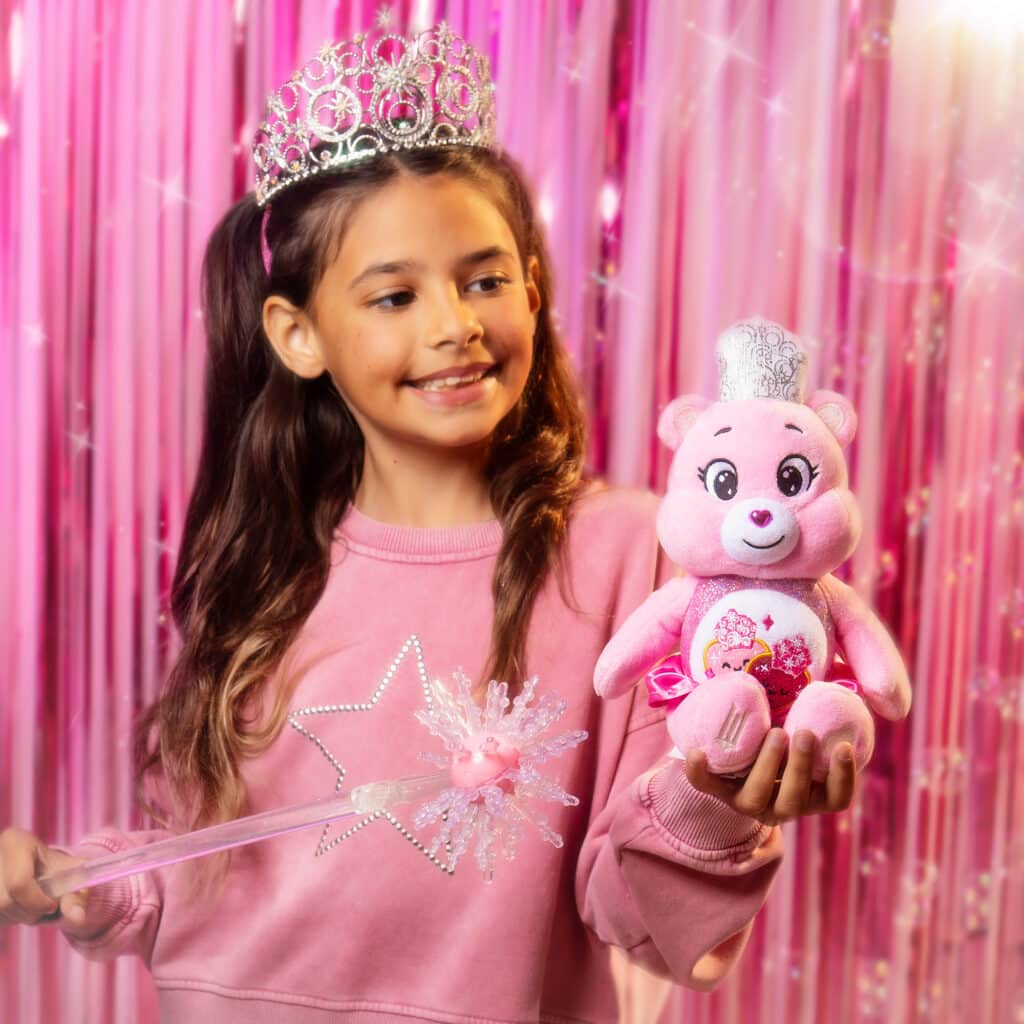 Little girl playing with the Love-A-Lot Bear as Glinda