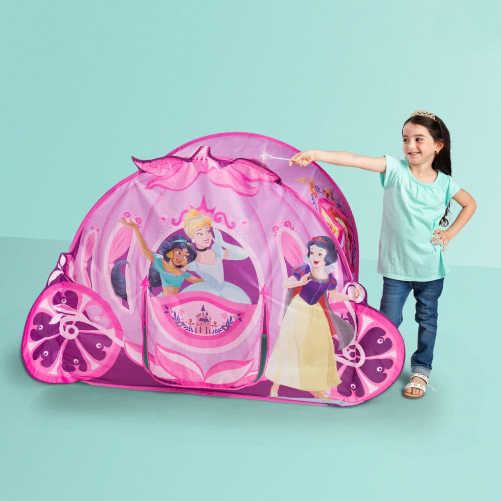 Little girl playing with the Playhut Disney Princess Carriage Crawl Through