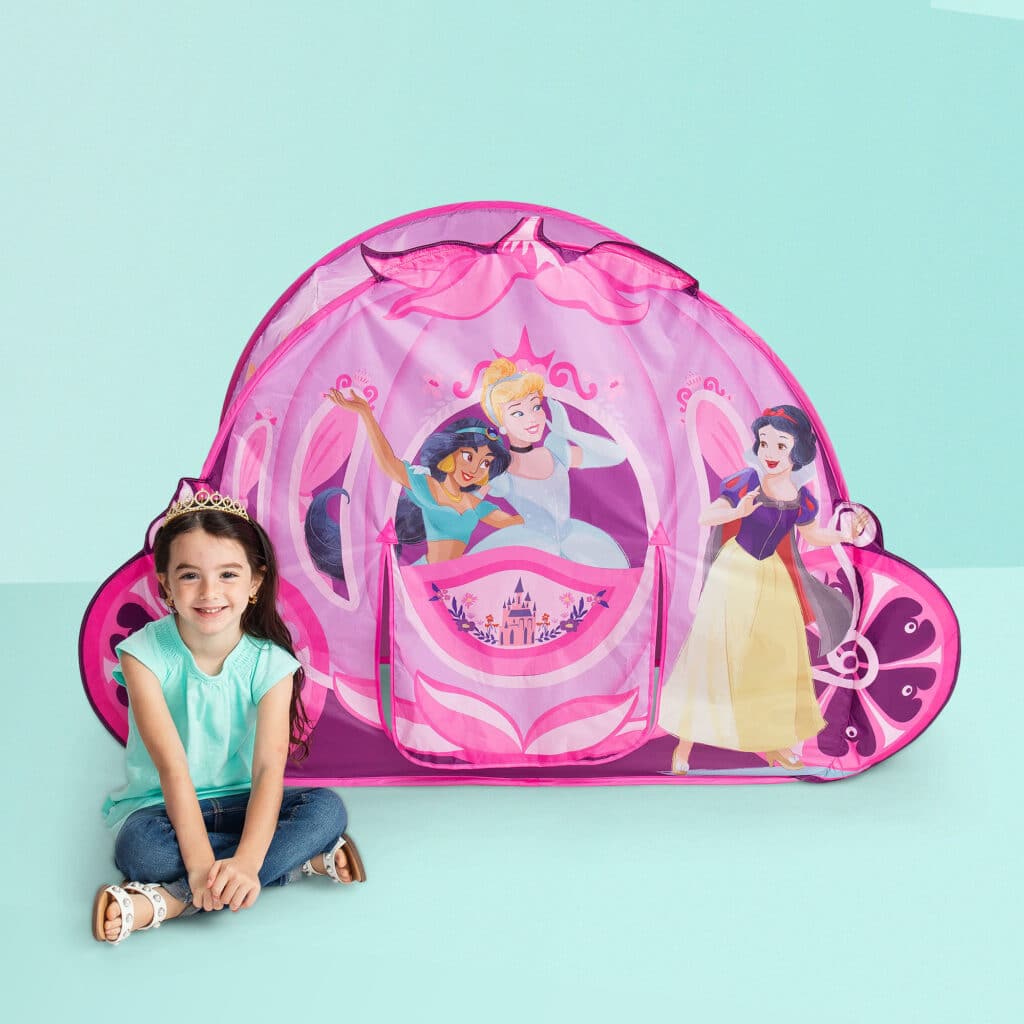 Little girl playing with the Playhut Disney Princess Carriage Crawl Through